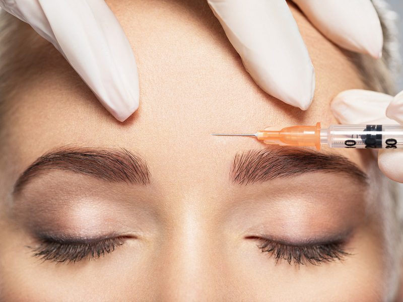 Reduce Pain of Injections Woman getting cosmetic injection of botox near eyes, close up.